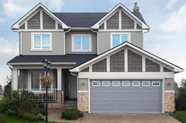 A house with a grey garage door.