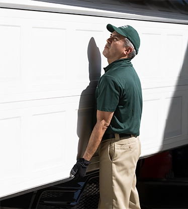 A PDS expert lifts a garage door.